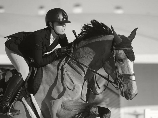 Rider wearing For Horses over jumps